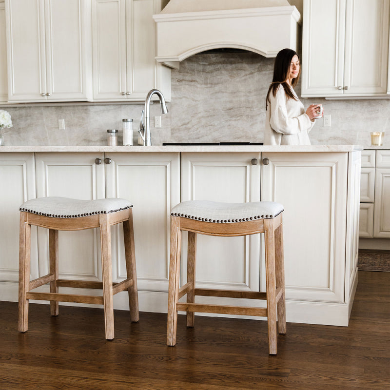 Maven Lane Adrien Saddle Counter Stool in Weathered Oak Finish w/ Sand Color Fabric Upholstery